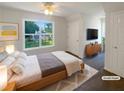 Cozy bedroom with a ceiling fan and bright window to the backyard at 132 Lynnview Ct, Mcdonough, GA 30252