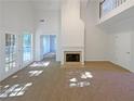Spacious living room featuring tall ceilings and a fireplace with many windows allowing for natural light at 132 Lynnview Ct, Mcdonough, GA 30252