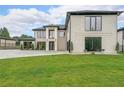 Beautiful home with a large green lawn and modern architectural design at 2751 Camp Branch Rd, Buford, GA 30519