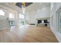 Bright, open-concept living room with high ceilings, fireplace, and hardwood floors at 2751 Camp Branch Rd, Buford, GA 30519