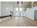 Spacious living room with large windows, modern fireplace, and hardwood floors at 2751 Camp Branch Rd, Buford, GA 30519