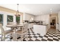 Bright eat-in kitchen with white cabinets, black countertops, checkerboard floors, and stainless steel appliances at 1935 Northbrooke Ln, Dunwoody, GA 30338
