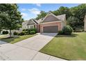Attractive home with a brick and siding exterior, complemented by a well-maintained lawn at 1955 Overlook Run Pl, Cumming, GA 30040