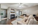 Cozy living room featuring a fireplace, hardwood floors, and neutral color palette at 2910 Cross Creek Dr, Cumming, GA 30040