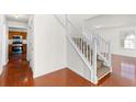 Bright entryway featuring hardwood floors, a staircase, and a view into the kitchen at 3448 Craggy Perch, Douglasville, GA 30135