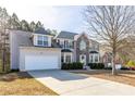 Inviting two-story home with a two-car garage and a long driveway, nestled in a wooded area at 3448 Craggy Perch, Douglasville, GA 30135