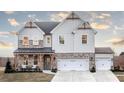 Elegant two-story house featuring a harmonious combination of siding and brick, complemented by a spacious two-car garage at 4720 Montane St, Cumming, GA 30028