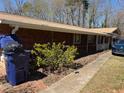 Exterior view of the side of the brick home with a blue trash can on a brick pad at 5317 Kings Hwy, Douglasville, GA 30135