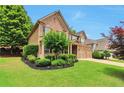 Charming two-story home featuring manicured landscaping and a welcoming front porch at 5613 Lancashire Ln, Cumming, GA 30041