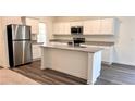 Modern kitchen with stainless steel appliances, granite countertops, and a central island at 60 Sonoma Drive, Dallas, GA 30157