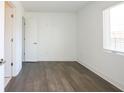 Sunlit bedroom with hardwood floors, white walls, and a window with blinds at 1145 Kirkwood Se Ave # 14, Atlanta, GA 30316