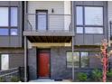 Contemporary townhouse showcasing dark brick, a private balcony, and an inviting red front door at 1145 Kirkwood Se Ave # 14, Atlanta, GA 30316