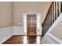 Welcoming entryway with a stained wood door, sidelights, and hardwood floors, next to a staircase at 2995 Belshire Trl, Dacula, GA 30019