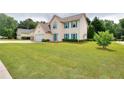 Attractive two-story home with lush lawn, cheerful turquoise shutters and door at 2995 Belshire Trl, Dacula, GA 30019