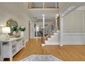 Inviting foyer with hardwood floors, a staircase, and elegant decor creating a grand entrance at 415 Winn Park Ct, Roswell, GA 30075