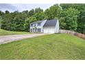 Lovely two-story home with an attached two-car garage, landscaped yard, and long driveway at 4975 Rockstone Way, Acworth, GA 30101