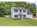 Charming home with light blue siding, bright shutters, and a well-maintained lawn with mature trees at 4975 Rockstone Way, Acworth, GA 30101