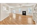 Open-concept living room with wood floors, fireplace, built-in shelves and lots of natural light at 1186 Hawthorn Ln, Grayson, GA 30017
