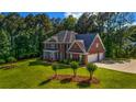 Lovely two-story brick house with a well-maintained yard and an attached two-car garage at 125 Legacy Way, Oxford, GA 30054