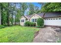 Traditional home with a two-car garage and mature landscaping at 273 Apalachee Church Rd, Auburn, GA 30011