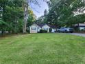 Inviting single-story home with a well-manicured lawn and a vehicle parked in the driveway at 273 Apalachee Church Rd, Auburn, GA 30011