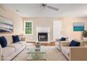 Staged living room with fireplace, white sofa, armchairs, and plush area rug at 273 Apalachee Church Rd, Auburn, GA 30011