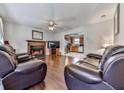 Cozy living room with hardwood floors, a fireplace, and comfortable leather seating at 504 Hillcrest Cross Rd, Canton, GA 30115