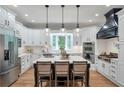 Bright kitchen with stainless steel appliances, center island, and white cabinets at 5145 Saddlebred Ln, Cumming, GA 30028
