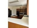 Traditional kitchen featuring wood cabinets, white countertops, island cooktop, and stainless steel appliances at 6868 Wynbrooke Cv, Stone Mountain, GA 30087