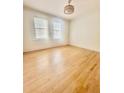 Light-filled bedroom with hardwood floors and minimalist decor for a serene atmosphere at 2230 Peachtree Road Nw Rd # A4, Atlanta, GA 30309