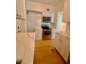 Modern kitchen with stainless steel appliances, white cabinets, and elegant countertop at 2230 Peachtree Road Nw Rd # A4, Atlanta, GA 30309