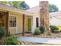 Inviting front entrance with a bright green door, stone pathway, and well-manicured landscaping at 2405 Ingram Rd, Duluth, GA 30096