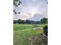 Expansive green yard leading to a serene lake view, ideal for relaxation and recreation at 2752 Inverloch Cir, Duluth, GA 30096