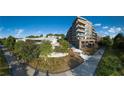 Contemporary condo building with walking trail access surrounded by trees and blue sky background, offering modern living at 675 Drewry Ne St # 205, Atlanta, GA 30306