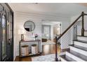 Bright foyer showcasing hardwood floors, shiplap walls, staircase with cable railing, and stylish decor at 225 Carriage Station Cir, Roswell, GA 30075