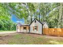 Attractive home featuring a covered porch and a modern privacy fence at 500 Pomoma Circle Sw, Atlanta, GA 30315