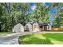 Beautiful single-Gathering home featuring lush greenery and a detached garage at 500 Pomoma Circle Sw, Atlanta, GA 30315
