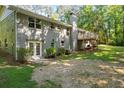 Expansive backyard featuring a deck, patio, and brick exterior, providing ample space for outdoor enjoyment at 6133 Post Rd, Douglasville, GA 30135