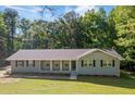 Well-maintained single-story home featuring a welcoming front porch, neat landscaping, and a classic design at 6133 Post Rd, Douglasville, GA 30135