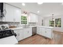 Updated kitchen with white cabinets, stainless steel appliances, and hardwood floors at 2863 Landing Dr, Marietta, GA 30066