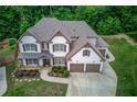 Aerial view of this spacious home featuring well-manicured lawn and a three car garage at 4241 Summer Breeze Way, Buford, GA 30518