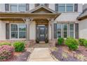 Charming front porch welcomes you with stone accents and manicured landscaping at 4241 Summer Breeze Way, Buford, GA 30518