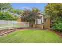 Cozy bungalow with a lush lawn and a charming white picket fence at 636 Cameron Street Se St, Atlanta, GA 30312