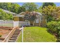 A cozy home with a well-maintained lawn and classic white picket fence at 636 Cameron Street Se St, Atlanta, GA 30312