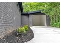 A large, empty garage with a brick exterior and concrete driveway at 998 Lookout Nw Ave, Atlanta, GA 30318