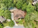 Aerial shot of a home featuring a private backyard with a swimming pool surrounded by lush greenery at 10135 High Falls Pointe, Johns Creek, GA 30022