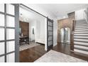 Inviting entryway featuring dark hardwood floors, a sliding barn door, and exposed brick at 410 Concord St, Alpharetta, GA 30009