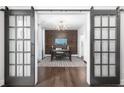 Well-lit home office with hardwood floors, a feature wall, and glass sliding doors at 410 Concord St, Alpharetta, GA 30009