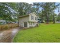 Well-maintained home featuring a convenient garage and complemented by a lush lawn and landscaping at 5461 Forest Path Ct, Stone Mountain, GA 30088