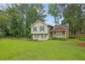 Well-maintained home on a lush lawn featuring mature trees, complemented by charming landscaping at 5461 Forest Path Ct, Stone Mountain, GA 30088